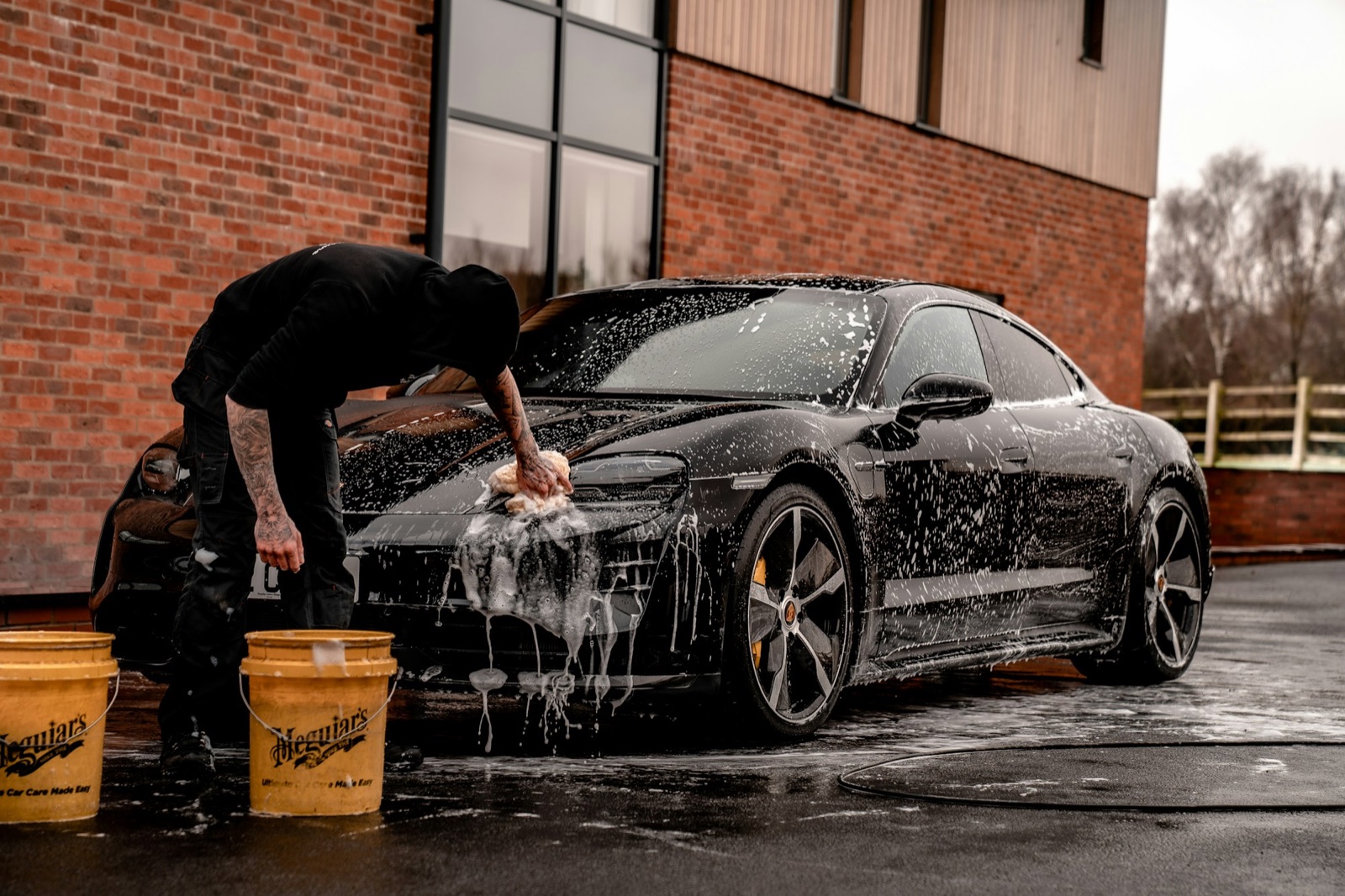 Hand-washing a car with rich soap suds